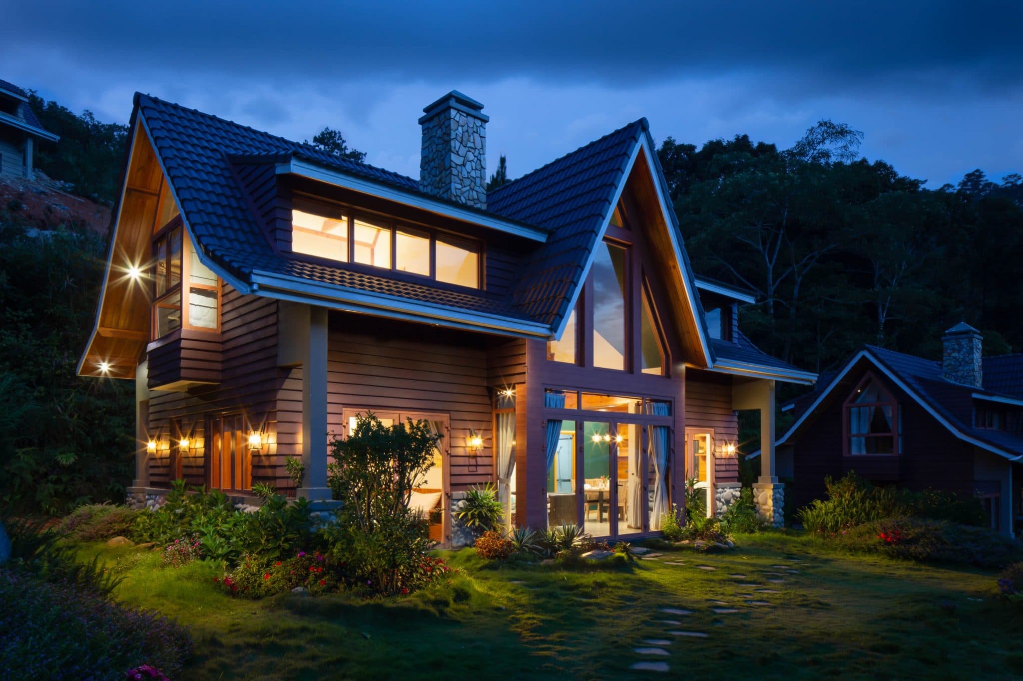 A detached family home lit up at dusk