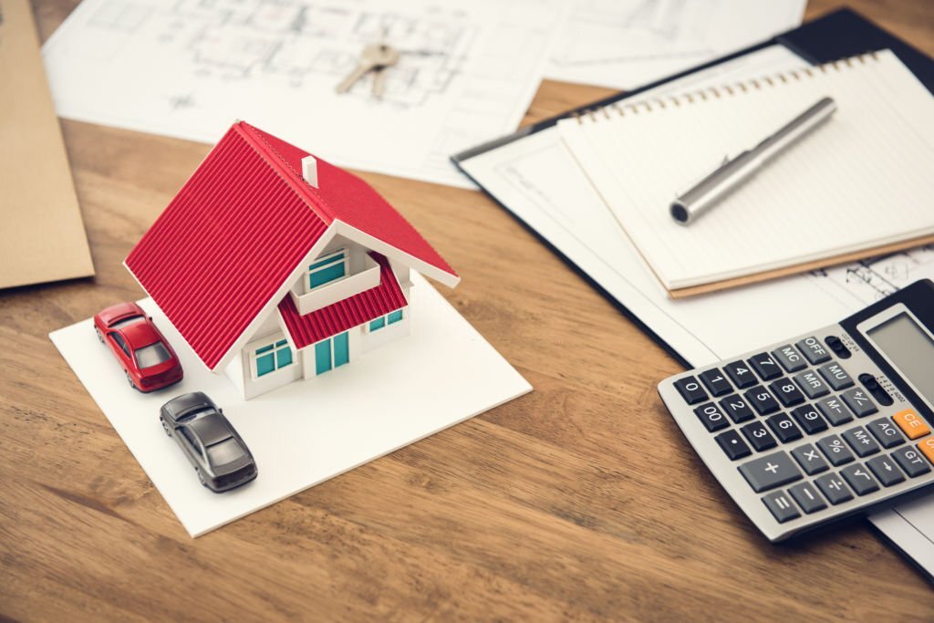 House model, calculator and documents on the table - real estate  financial concept